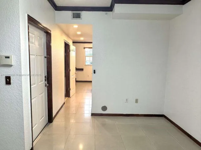 a view of a hallway with a room and a livingroom