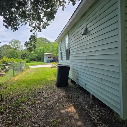 a view of a backyard with plants and outdoor seating