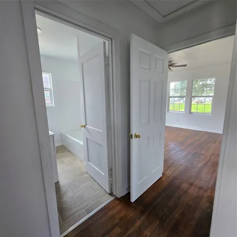 a view of a room with wooden floor and window