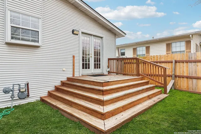 a view of a house with a backyard and stairs