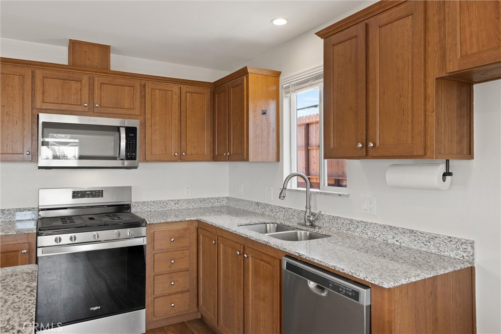1575 La Grand View Road Paradise, CA 95969 - Photo 14 of 38 a kitchen with stainless steel appliances granite countertop a sink stove and cabinets