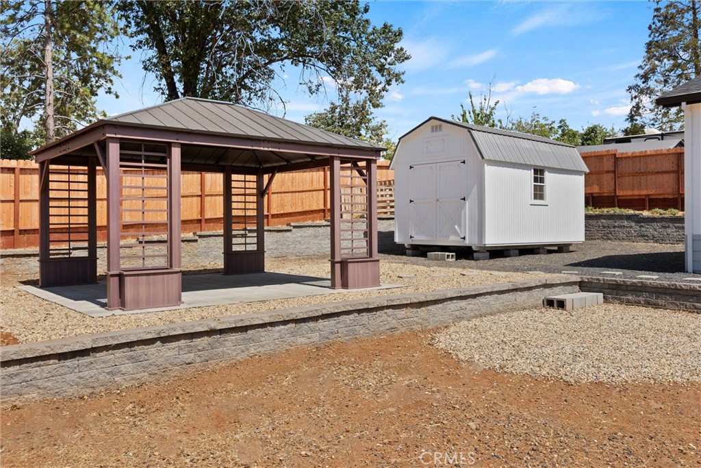 1575 La Grand View Road Paradise, CA 95969 - Photo 30 of 38 a view of a white house with a yard and fence
