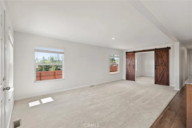 an empty room with a window and a ceiling fan
