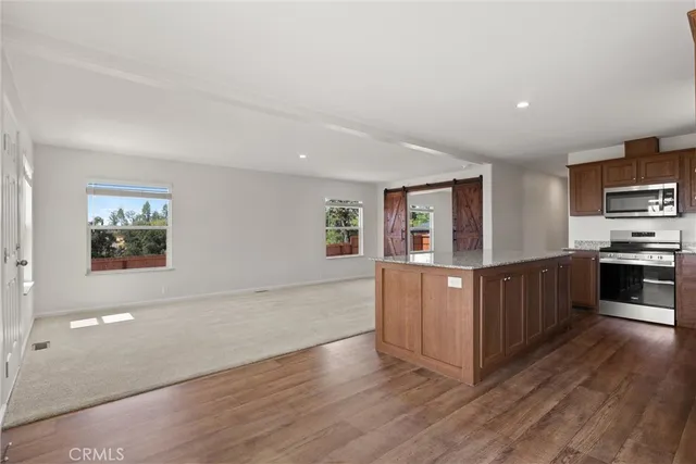 a kitchen with stainless steel appliances a refrigerator and a stove top oven