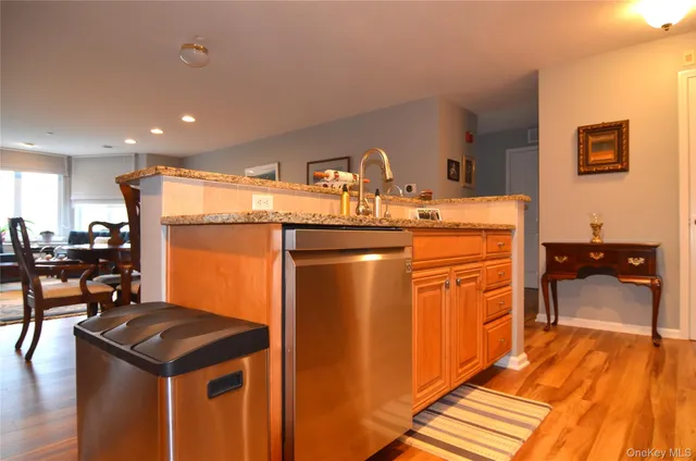 a kitchen with stainless steel appliances granite countertop a sink stove and wooden cabinets