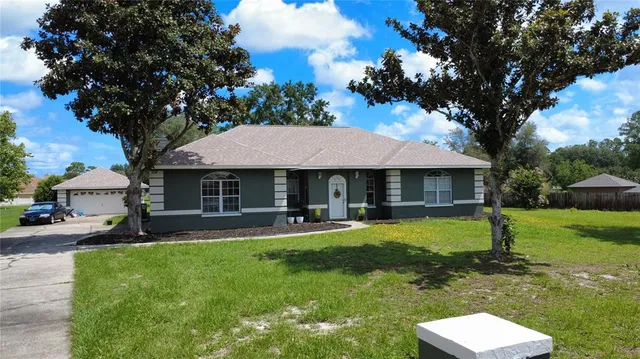 a front view of a house with a yard table and chairs
