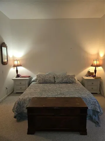 a bedroom with a bed and a lamp