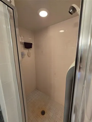 a bathroom with a shower and a mirror