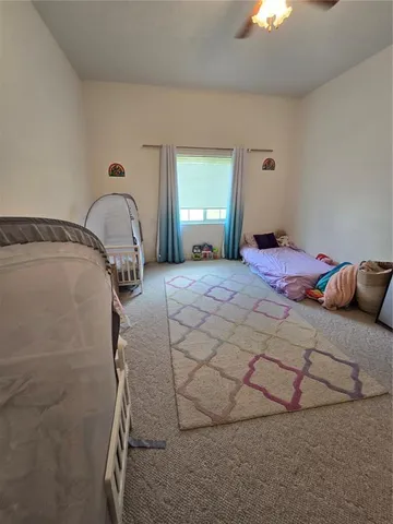 a bedroom with a bed and a mirror