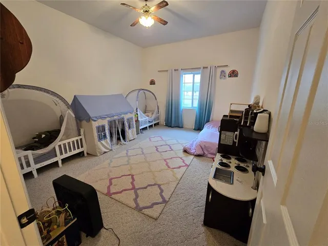 a living room with furniture and a mirror