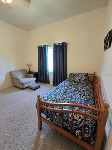 a bed sitting in a room next to a window