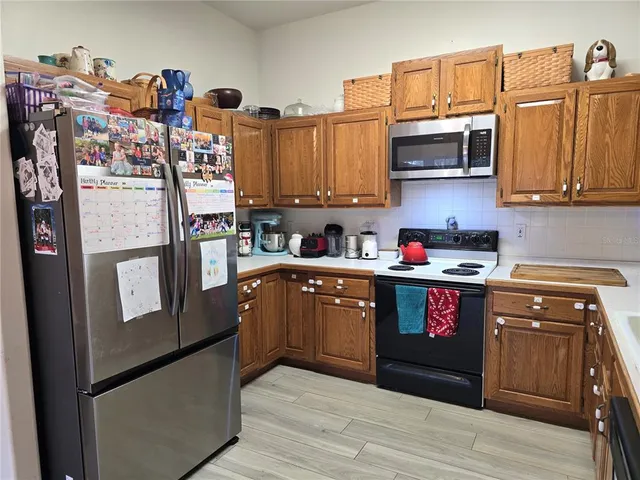 a kitchen with a sink a stove and cabinets