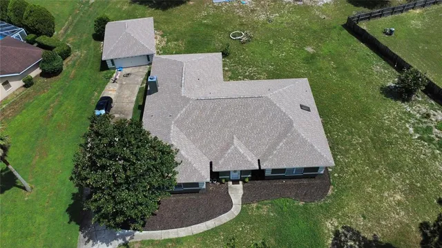 an aerial view of a house with garden space and street view