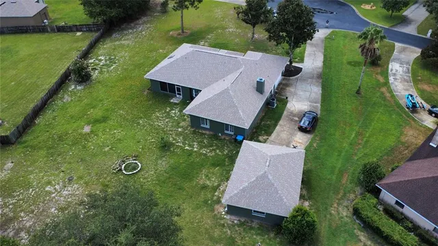 an aerial view of a house with yard