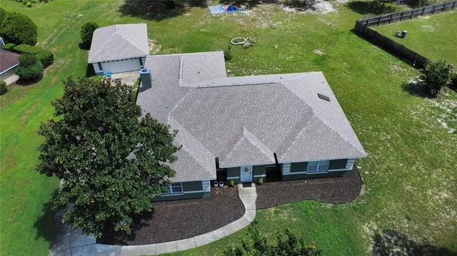 an aerial view of a house with garden space and street view