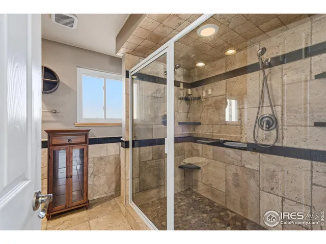a bathroom with a shower and a mirror