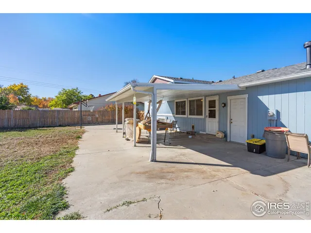 a view of a patio with a table and chairs