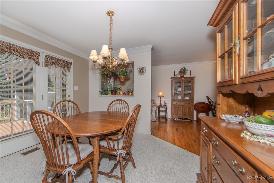 5720 Long Cove Road Midlothian, VA 23112 - Photo 7 of 31 a dining room with furniture and chandelier