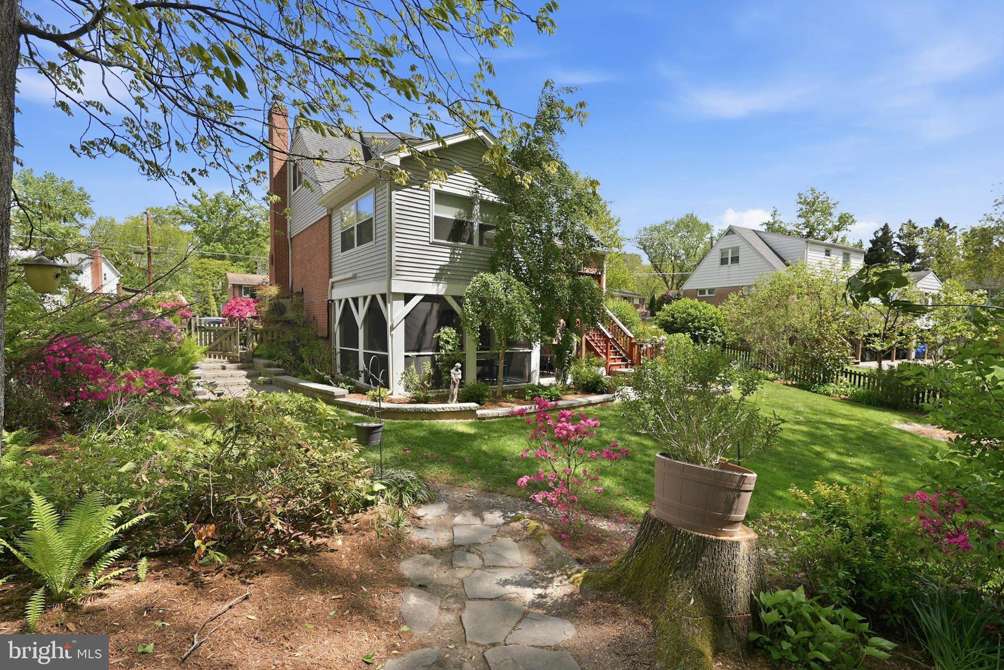 7006 Barnack Drive Springfield, VA 22152 - Photo 2 of 56 a view of a house with a yard and garden