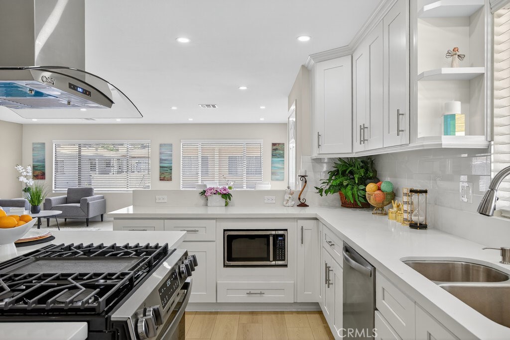 300 North Rampart Street, Unit 113 Orange, CA 92868 - Photo 1 of 1 a kitchen with stainless steel appliances granite countertop a stove and a sink