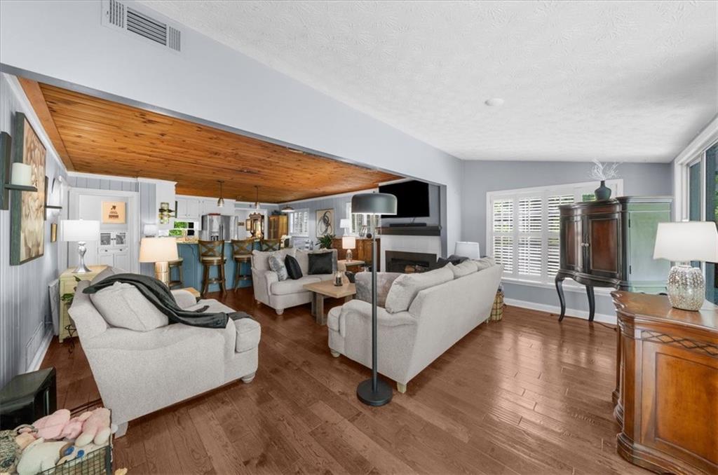 6551 Bermuda Lane Flowery Branch, GA 30542 - Photo 13 of 43 a living room with furniture and a wooden floor