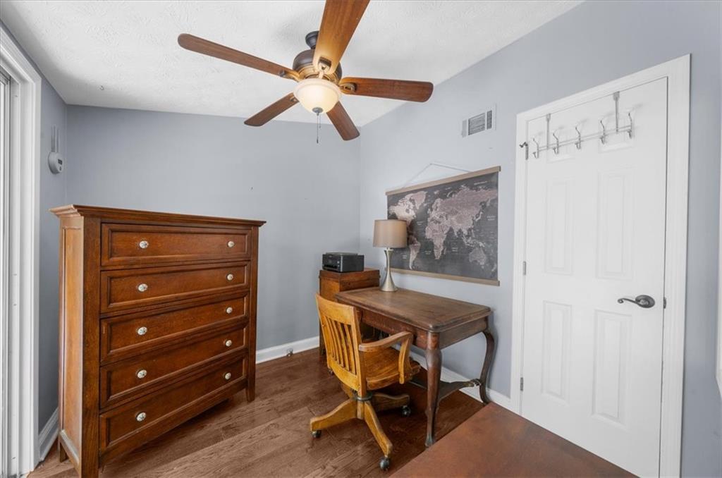 6551 Bermuda Lane Flowery Branch, GA 30542 - Photo 16 of 43 a dining room with a cabinet and a mirror