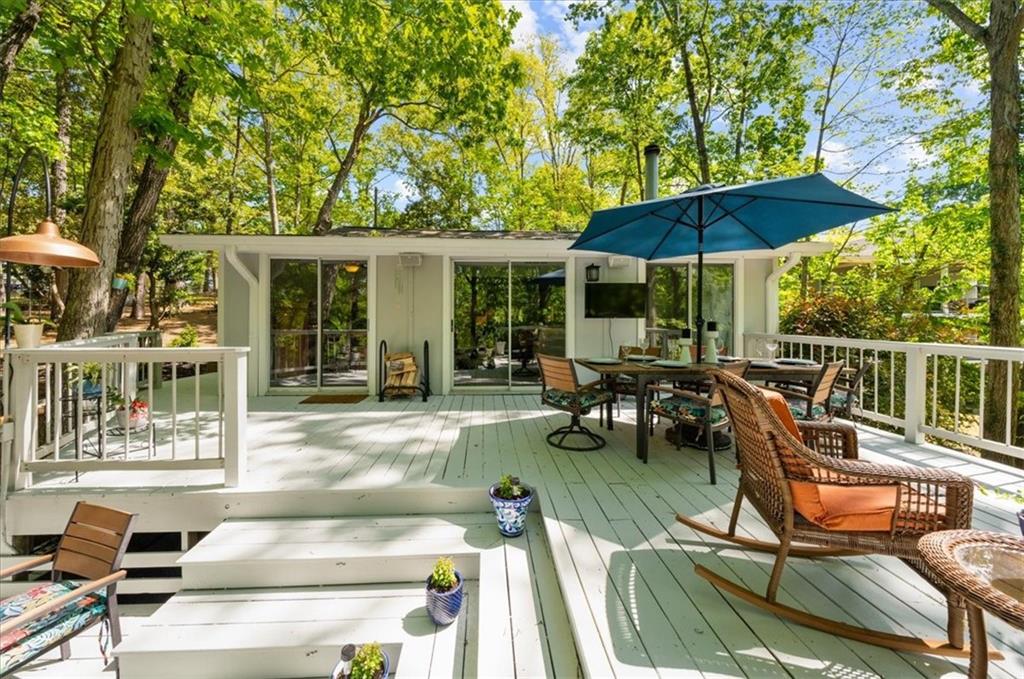 6551 Bermuda Lane Flowery Branch, GA 30542 - Photo 26 of 43 a view of a patio with table and chairs under an umbrella