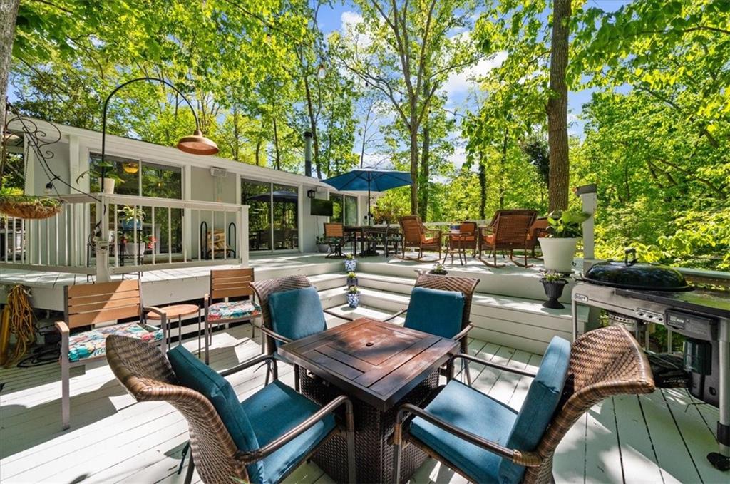 6551 Bermuda Lane Flowery Branch, GA 30542 - Photo 27 of 43 an outdoor living area with chairs and a table