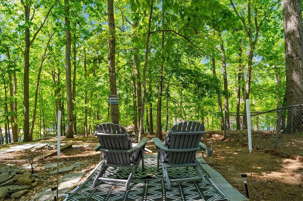 6551 Bermuda Lane Flowery Branch, GA 30542 - Photo 28 of 43 a view of a chairs and table in backyard