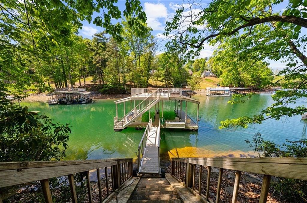 6551 Bermuda Lane Flowery Branch, GA 30542 - Photo 31 of 43 a view of a lake with houses