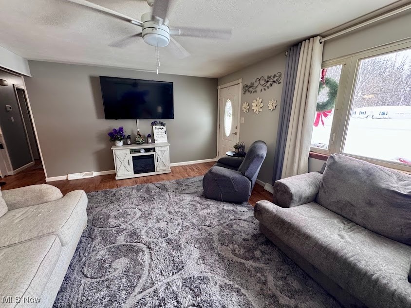 240 Spring Creek Road Northfield, OH 44067 - Photo 9 of 39 Living room with a textured ceiling, hardwood / wood-style flooring, and ceiling fan