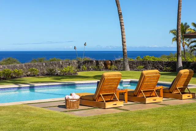 a view of a swimming pool with lounge chairs
