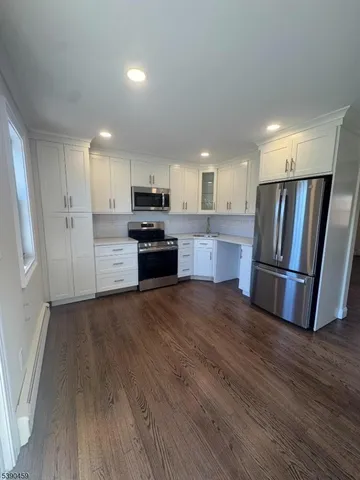a kitchen with stainless steel appliances a refrigerator sink and microwave