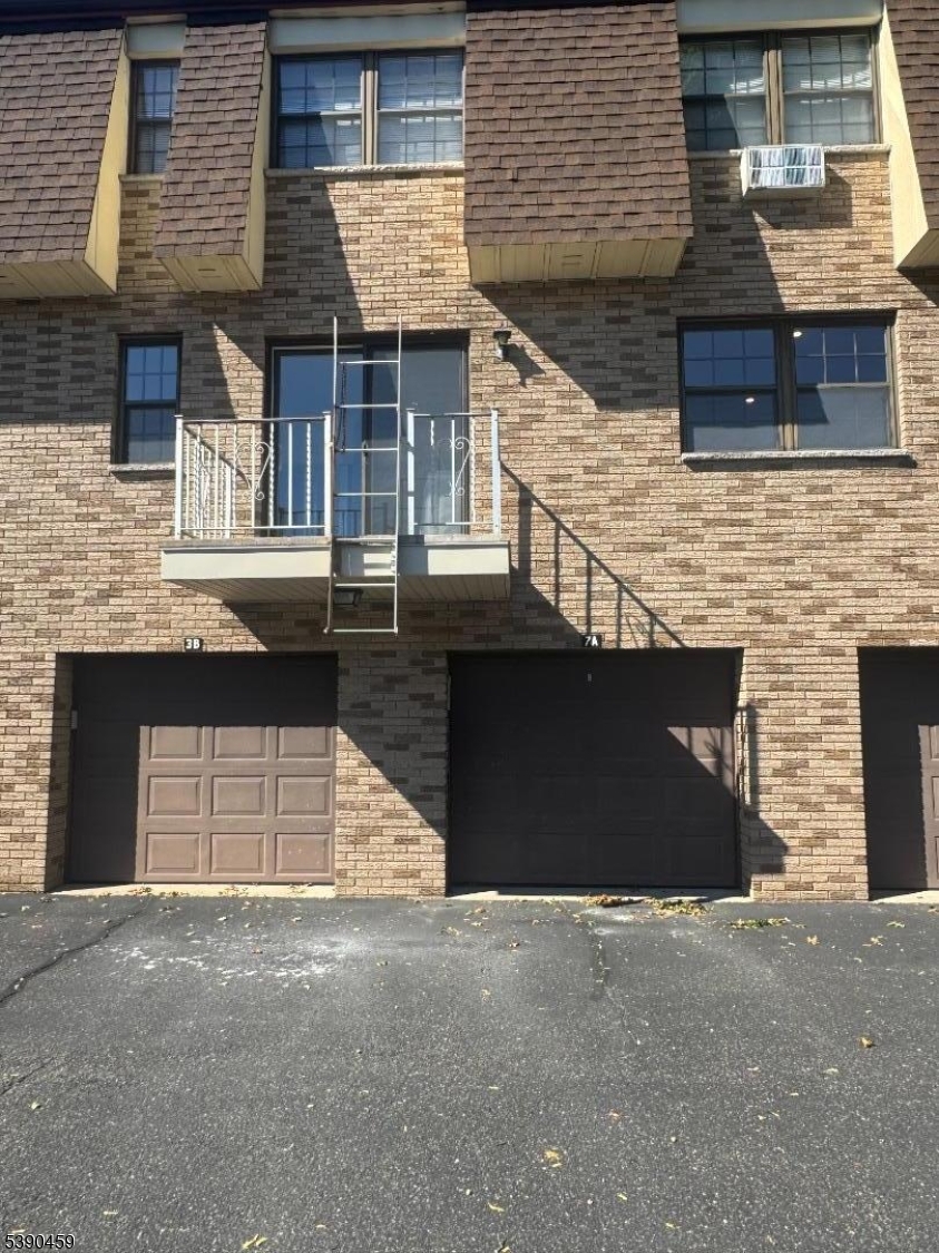 1240 Van Houten Avenue, Unit 7A Clifton, NJ 07013 - Photo 2 of 14 a front view of a house with a garage and window