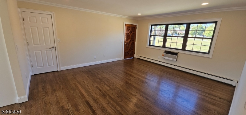 1240 Van Houten Avenue, Unit 7A Clifton, NJ 07013 - Photo 4 of 14 wooden floor in an empty room with a window