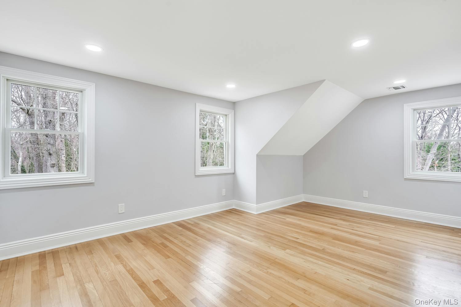 539 Split Rock Road Syosset, NY 11791 - Photo 30 of 40 Bonus room featuring baseboards, plenty of natural light, and light wood-style flooring