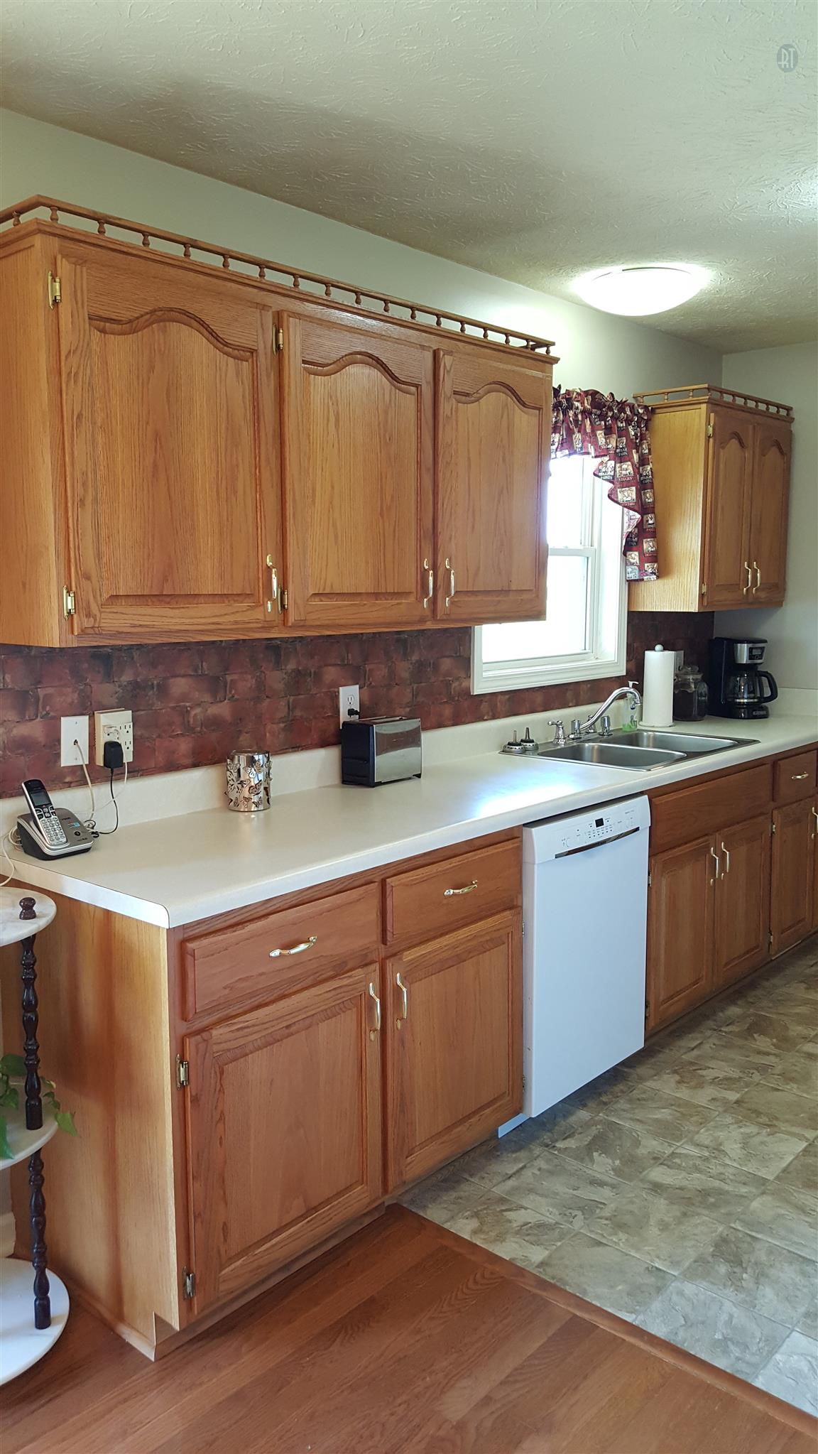 272 Collins Road Portland, TN 37148 - Photo 6 of 17 a kitchen with a sink cabinets and a window