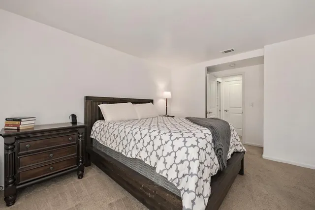 a bedroom with a bed and a dresser