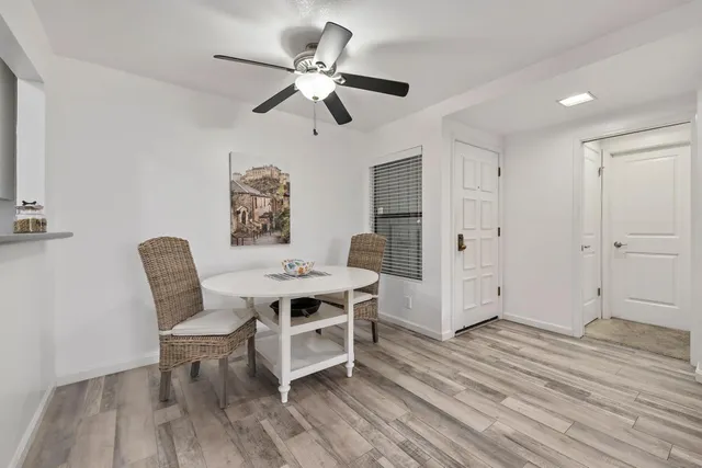 a view of a workspace room with wooden floor wooden floor and windows