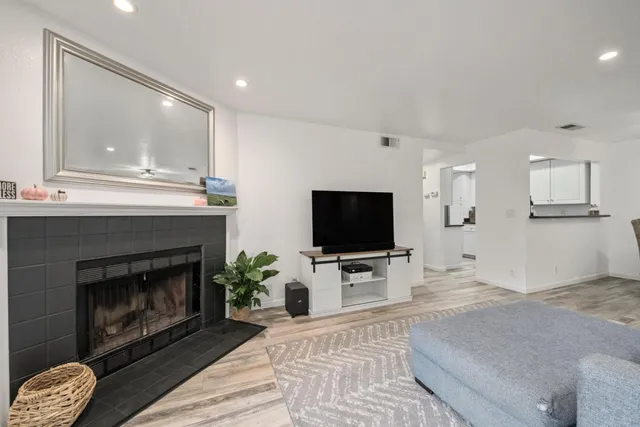 a living room with furniture and a fireplace or television