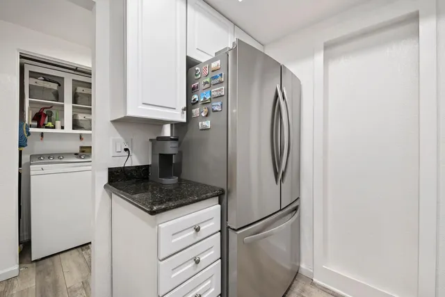 a kitchen with stainless steel appliances granite countertop a refrigerator and a stove
