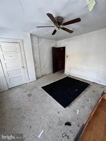 a bedroom with a bed and a ceiling fan