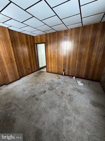 a view of an empty room with a window and door