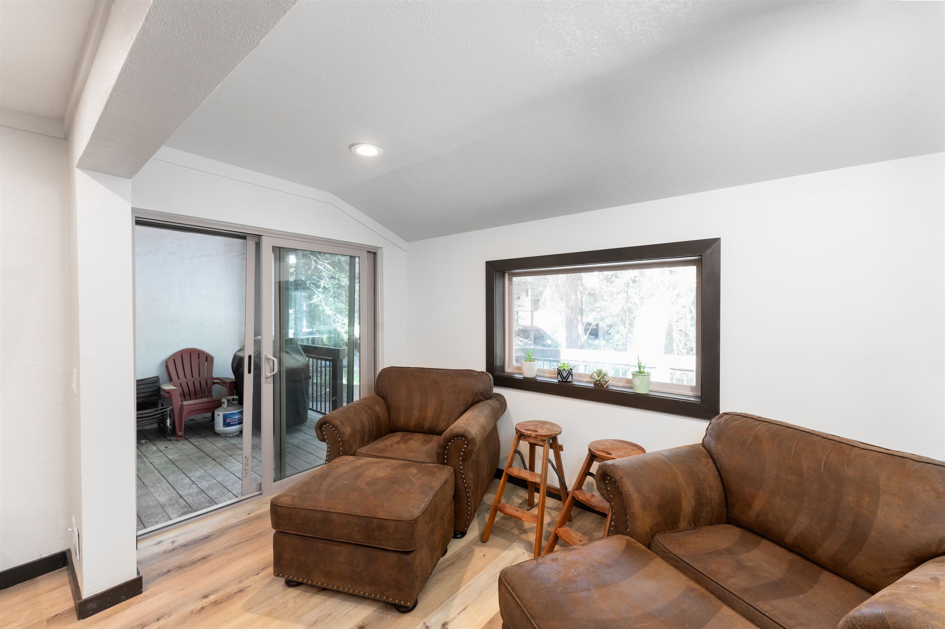 227 Olympic Vly Road, Unit 27 Olympic Valley, CA 96146 - Photo 14 of 21 a living room with furniture and a large window