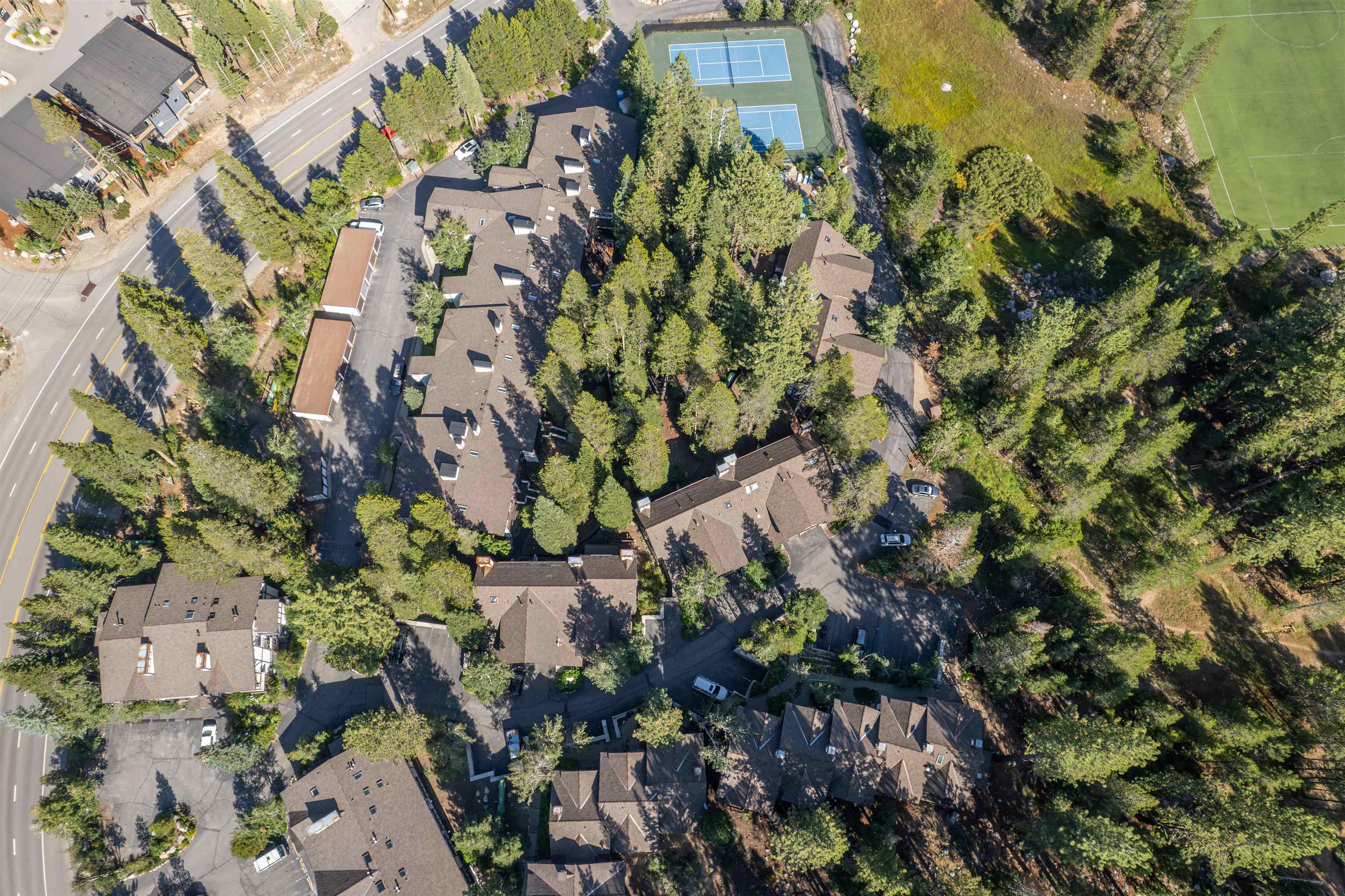 227 Olympic Vly Road, Unit 27 Olympic Valley, CA 96146 - Photo 19 of 21 a backyard of a building with lots of trees