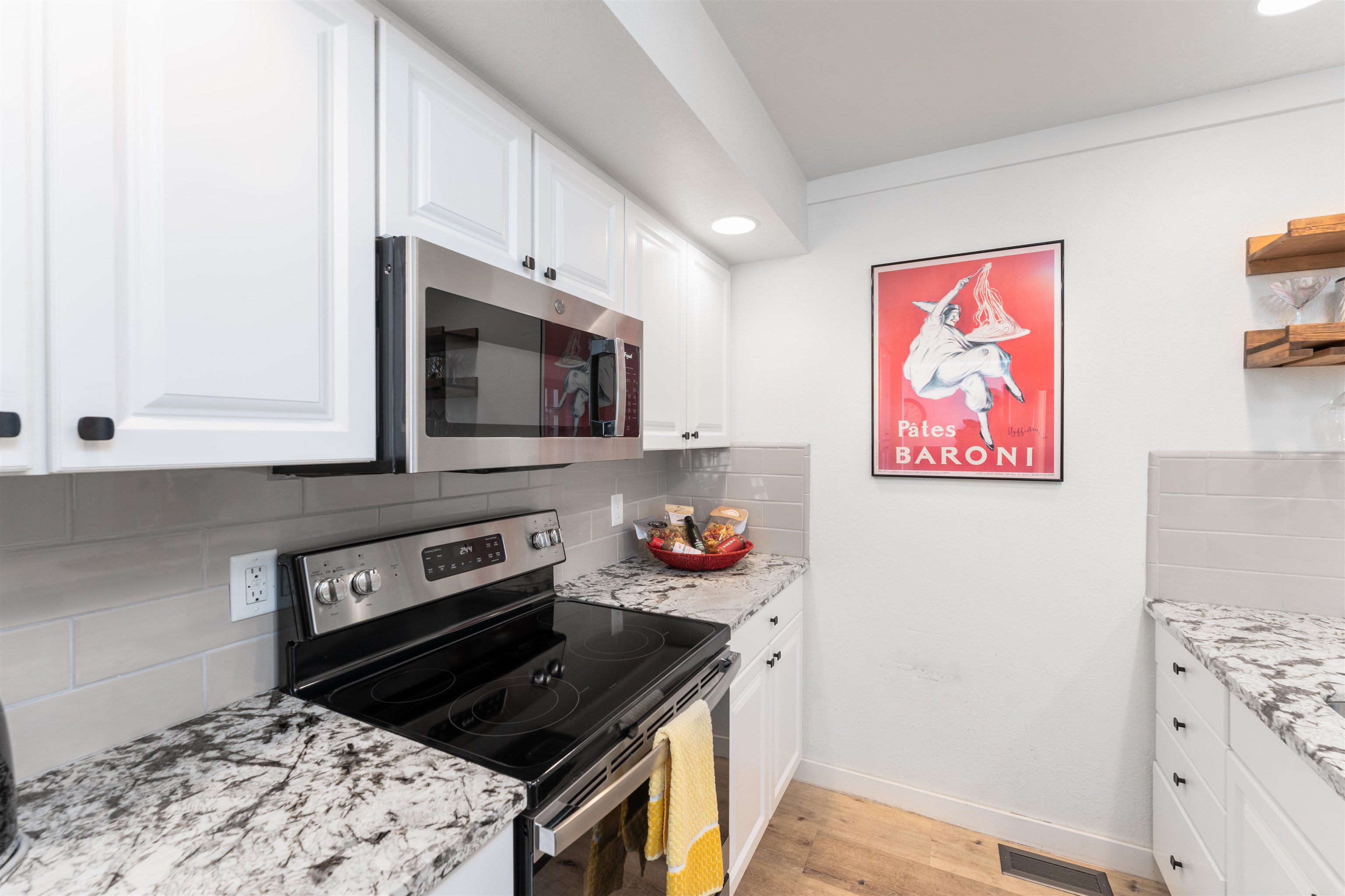 227 Olympic Vly Road, Unit 27 Olympic Valley, CA 96146 - Photo 5 of 21 a kitchen with stainless steel appliances a stove a microwave and cabinets