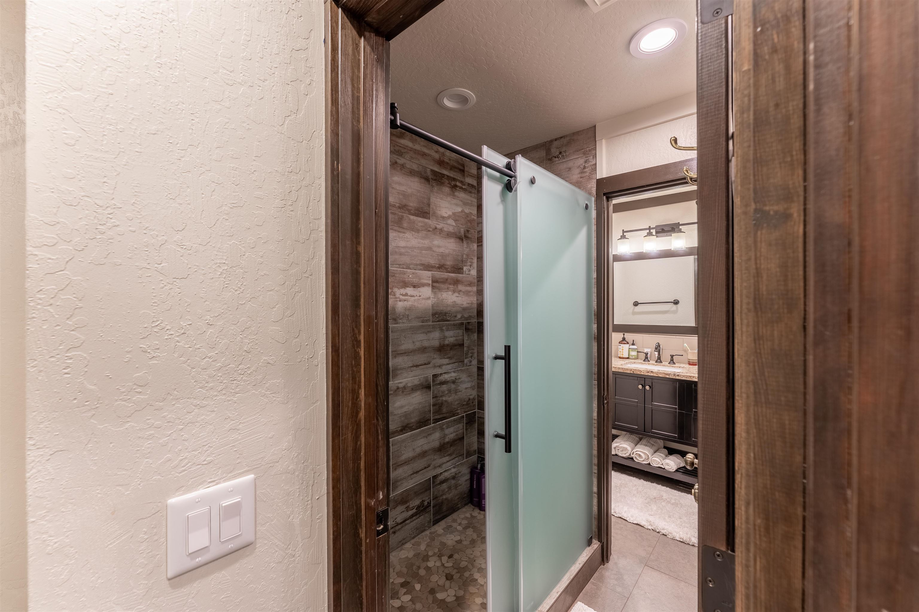 227 Olympic Vly Road, Unit 27 Olympic Valley, CA 96146 - Photo 8 of 21 a bathroom with a glass shower door