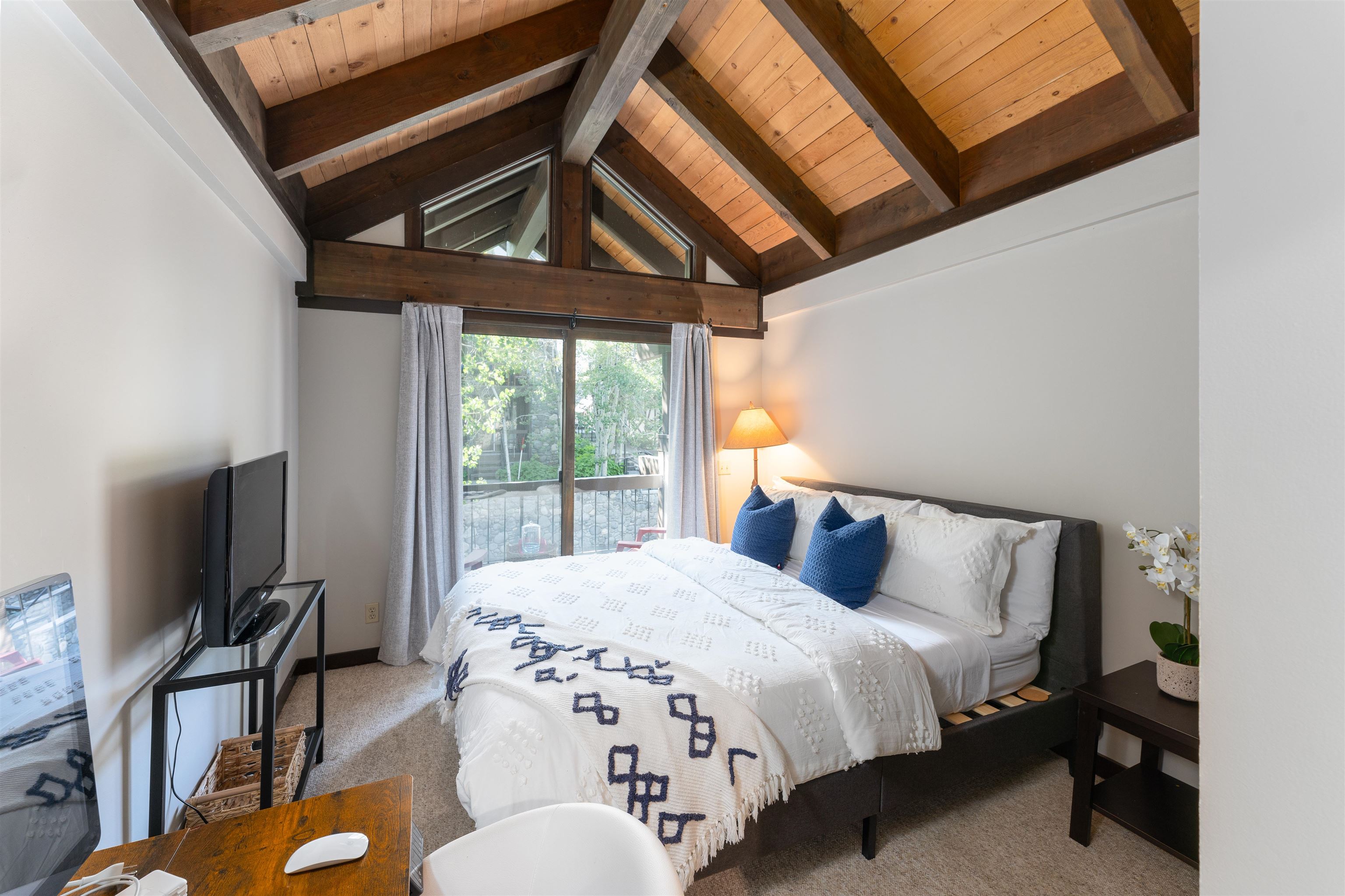 227 Olympic Vly Road, Unit 27 Olympic Valley, CA 96146 - Photo 9 of 21 a bedroom with a bed a flat screen tv and balcony