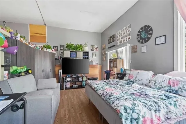 a bedroom with a bed and a flat screen tv