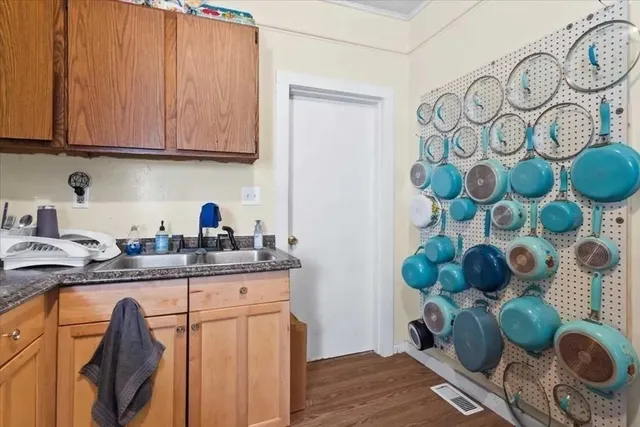 a kitchen with stainless steel appliances granite countertop a sink a stove and cabinets